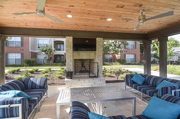 A patio with a fireplace and seating area  at Quail Ridge Apartment Homes, Bartlett, TN